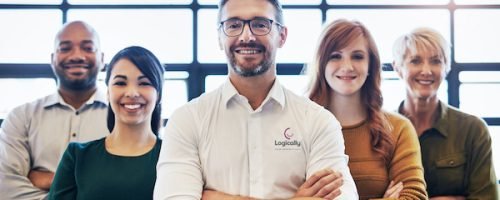 Cropped portrait of a team of colleagues standing together with their arms crossed in a modern office