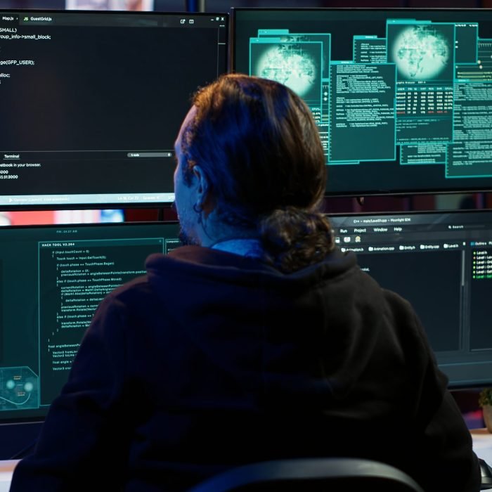 Cybercriminal uploading USB flash drive containing stolen information into computer. Scammer inserting storage device containing sensitive data obtained from security breach